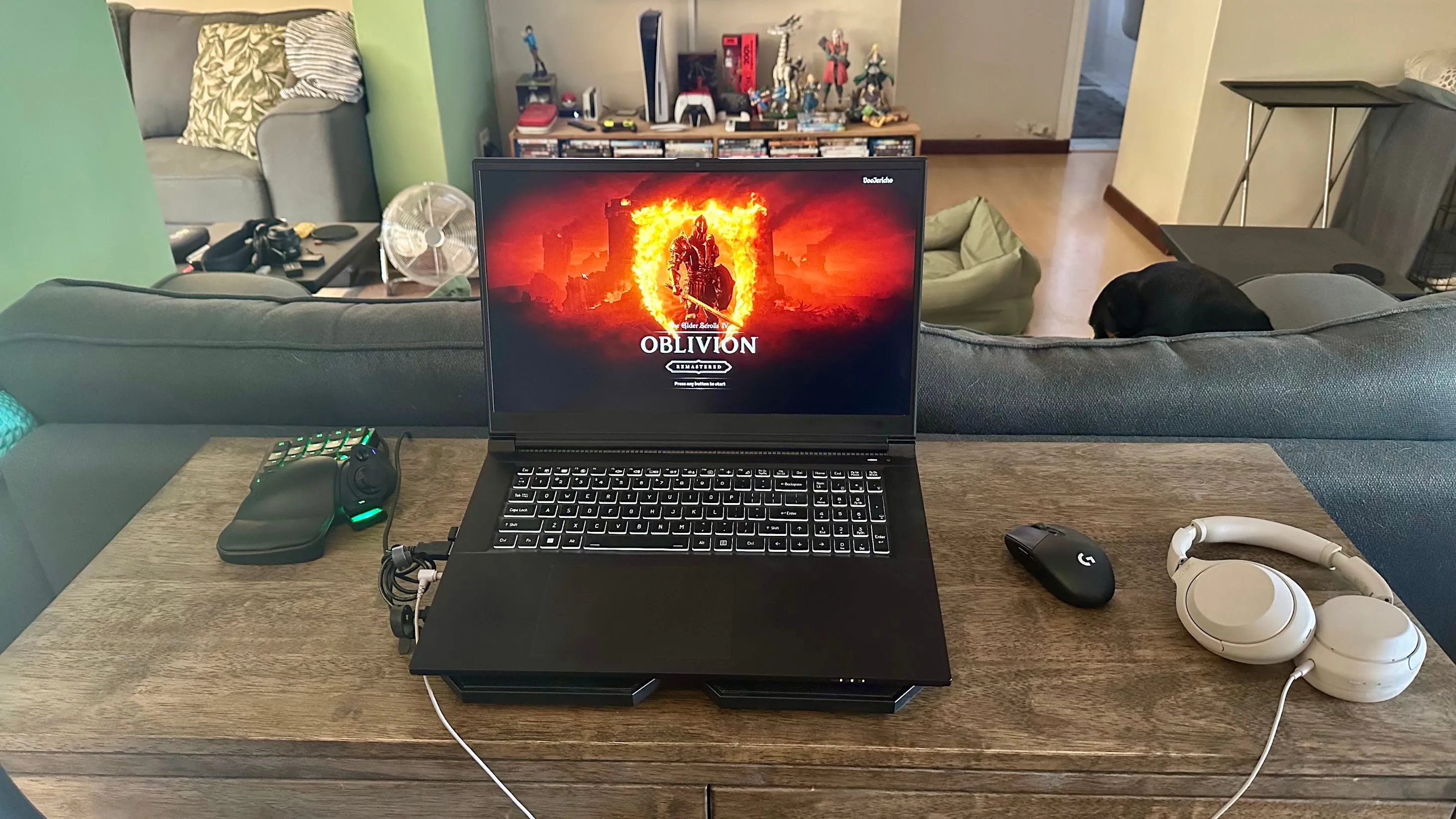 Laptop gaming trên đế tản nhiệt với bàn phím một tay Razer Tartarus bên trái.