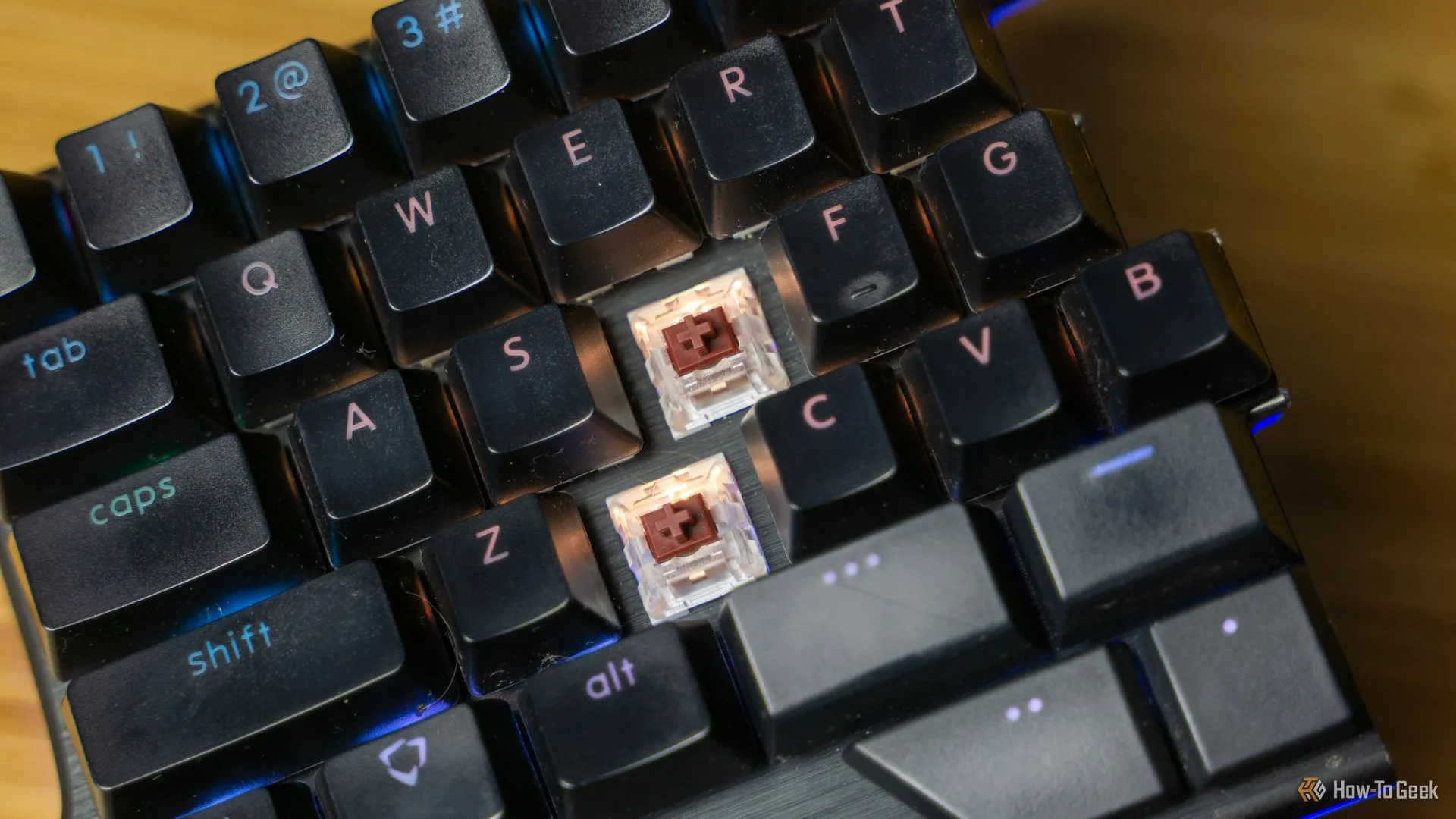 Bàn phím cơ Dygma Raise với một số keycap được tháo rời để lộ công tắc hot-swappable.