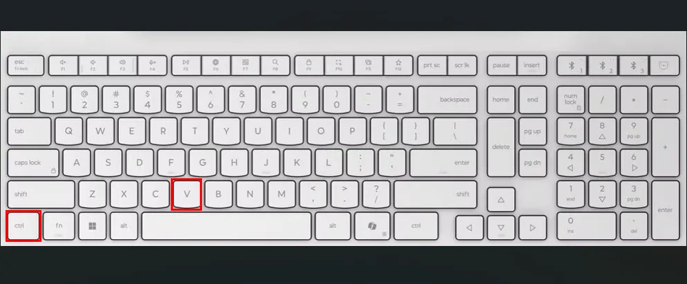 Bàn phím màu trắng với các ô màu đỏ làm nổi bật các phím Ctrl và V để dán nội dung trên Ubuntu.