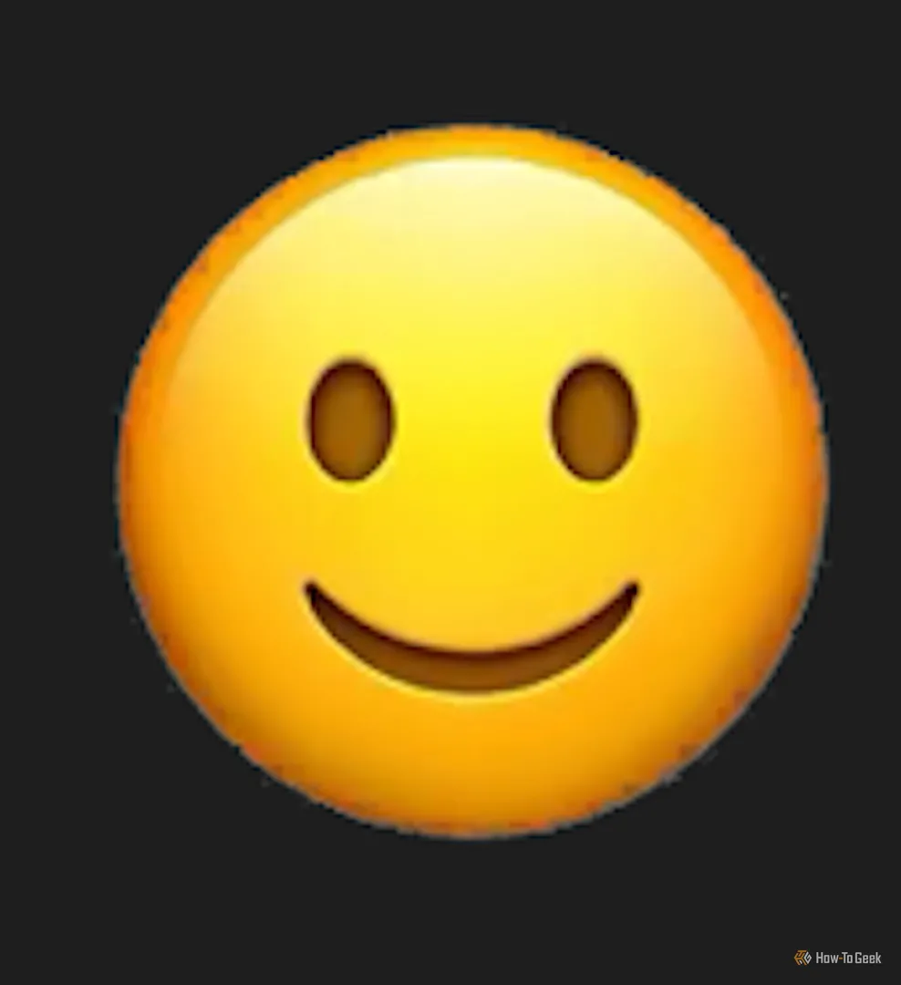 Emoji nụ cười rộng đáng sợ do Genmoji tạo ra, thuộc &quot;thung lũng kỳ lạ&quot; của AI, với đôi mắt vô hồn và biểu cảm ghê rợn.