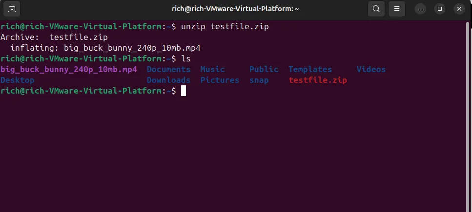 Giao diện Linux terminal minh họa lệnh unzip testfile.zip giải nén tệp video và lệnh ls liệt kê các tệp MP4 đã giải nén cùng với tệp ZIP gốc