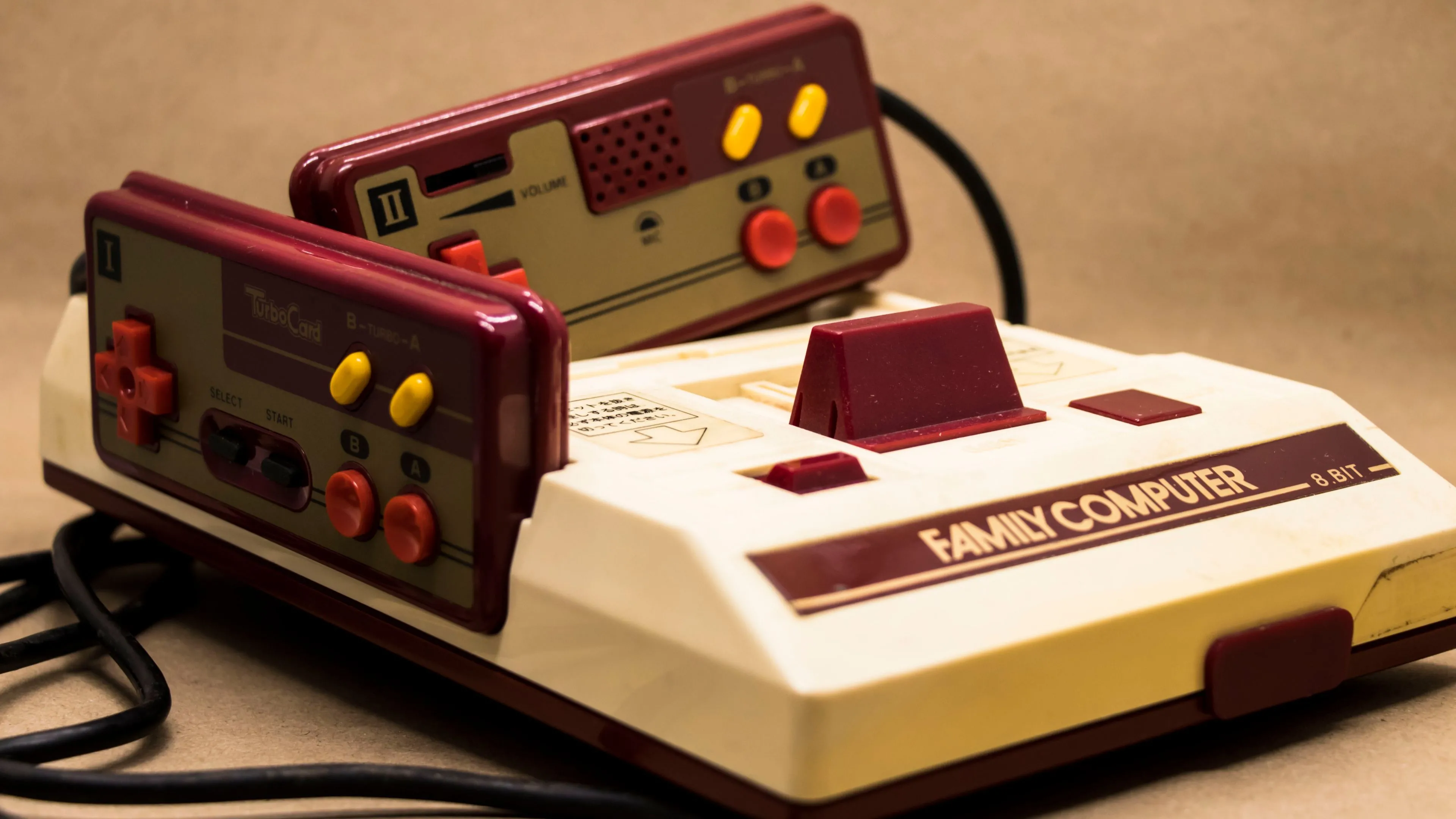 Hệ máy chơi game Nintendo Famicom với tay cầm màu đỏ đặc trưng gắn liền thân máy.