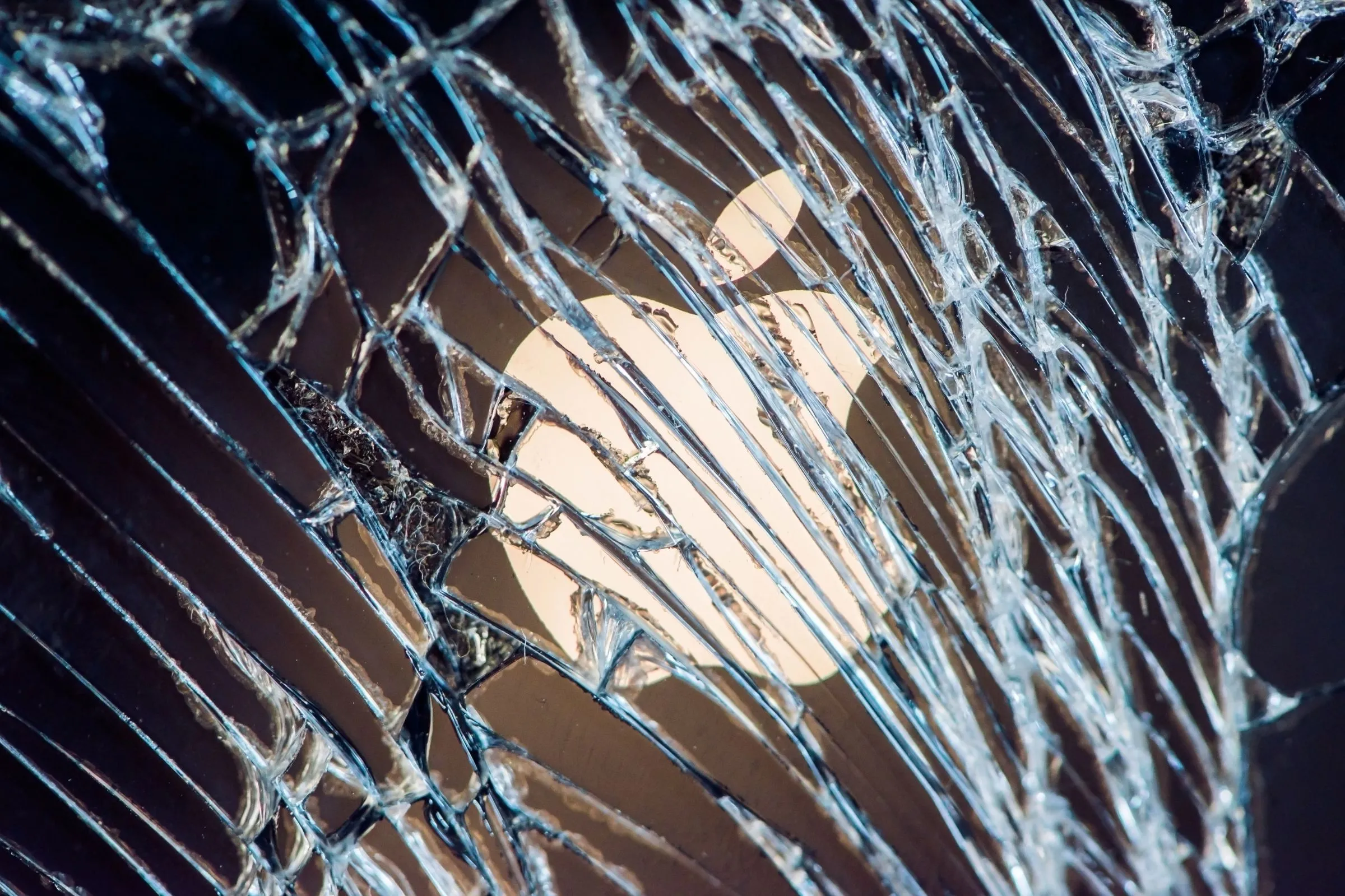 Màn hình iPhone bị nứt với logo Apple mờ hiện lên