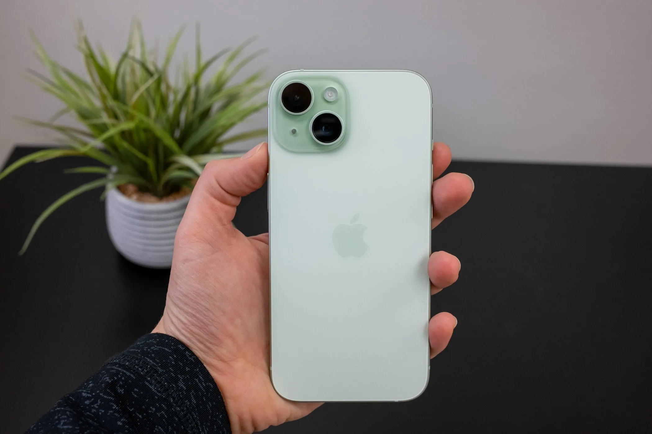 Người dùng đang cầm chiếc iPhone 15 màu hồng