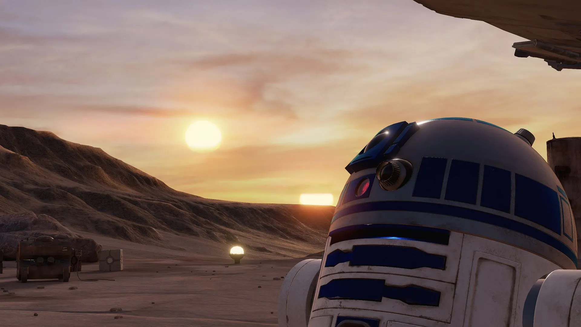 Robot R2-D2 đứng trên sa mạc Tatooine với phi thuyền Millennium Falcon và hoàng hôn rực rỡ trong game VR Star Wars Trials on Tatooine