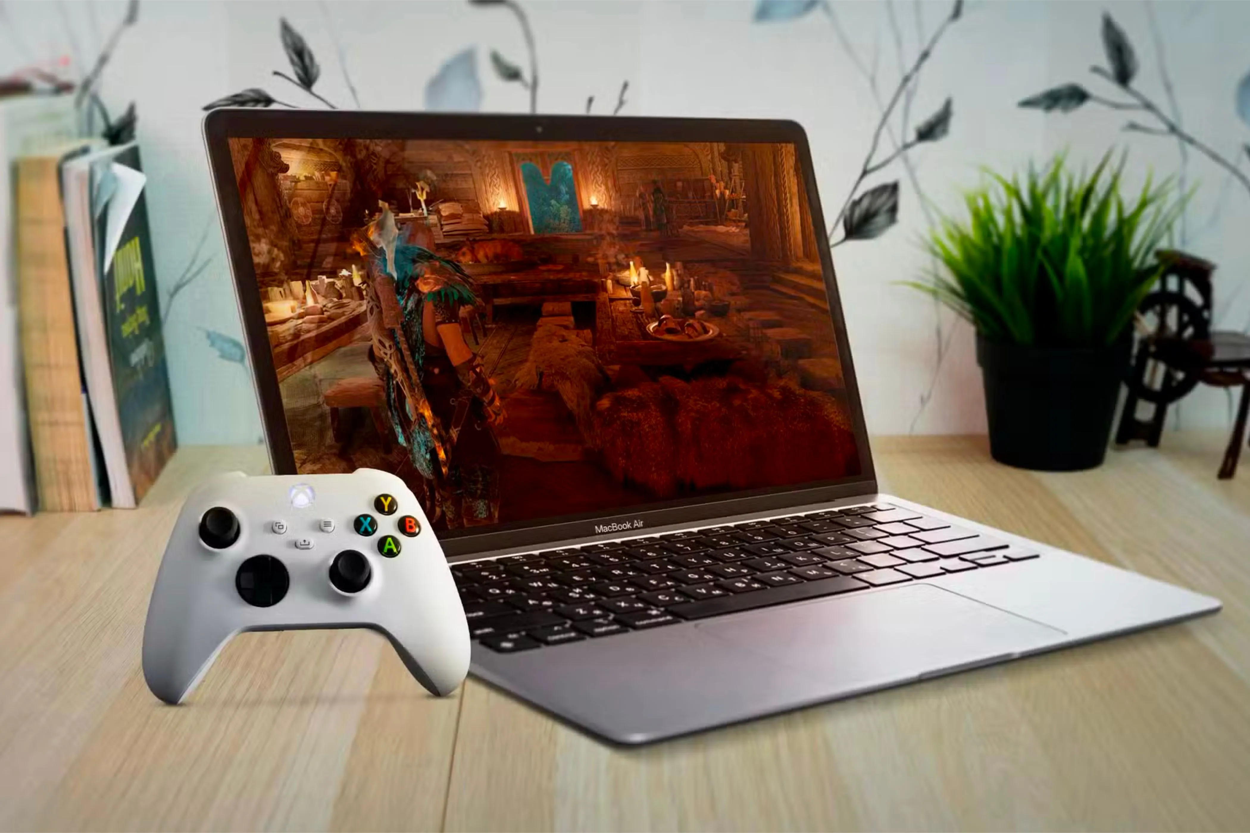 Một chiếc MacBook Air đang hiển thị màn hình game với tay cầm Xbox đặt bên cạnh, minh họa cách tối ưu trải nghiệm chơi game trên Mac